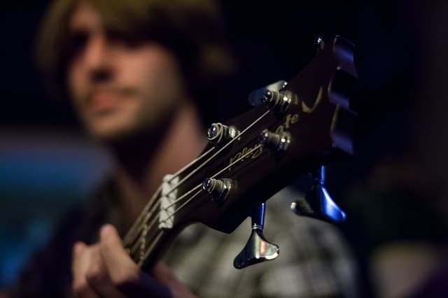 man playing bass guitar during song