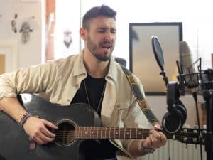 Man singing at home showing why you should avoid the mistake of not practising enough