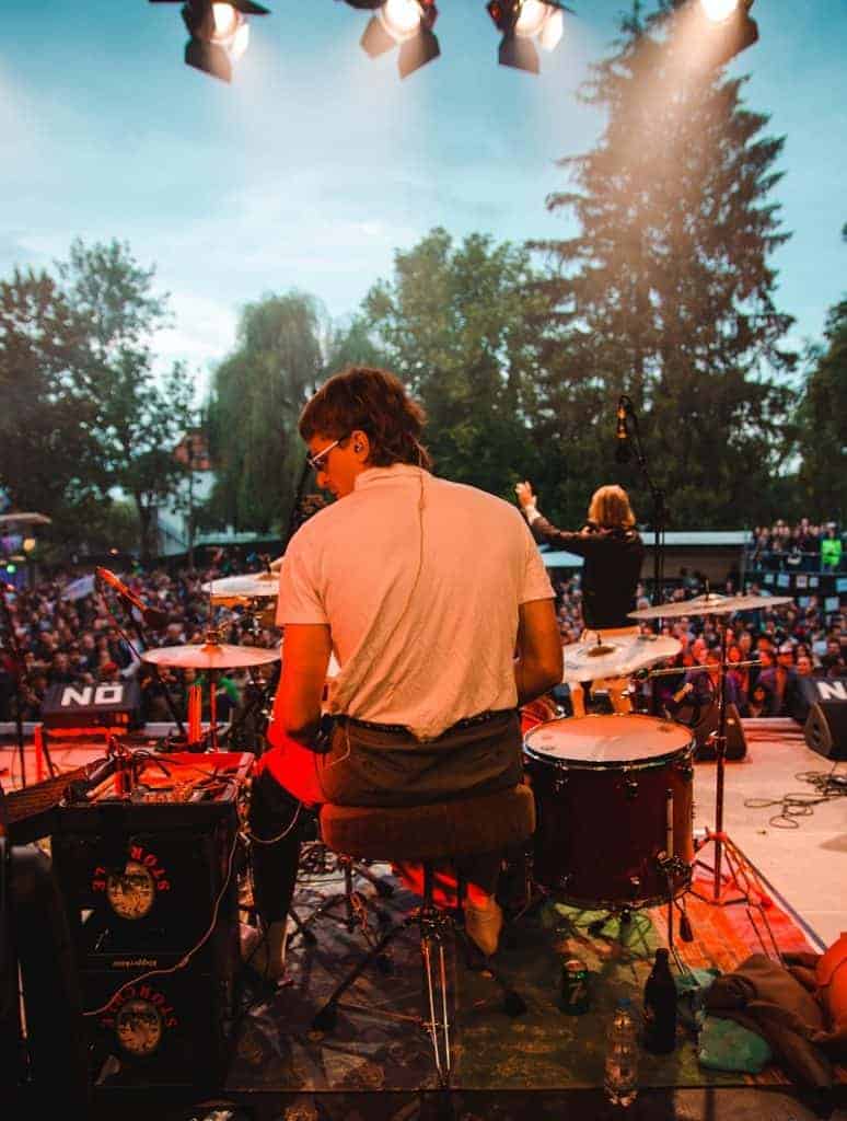 drummer on stage sitting on stool