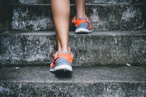 Lady caring for her voice with exercise by running up stairs