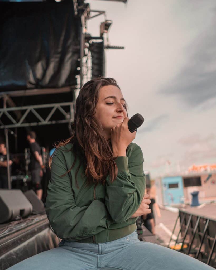 Female singer resting her voice sitting on stage