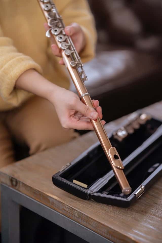 lady assembling a flute mouthpiece