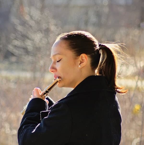 lady playing flute outside