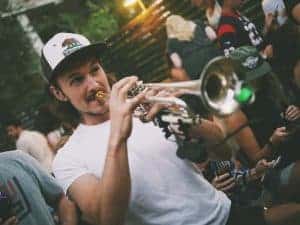 man in a cap playing the trumpet