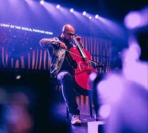 Man playing cello sitting on stage