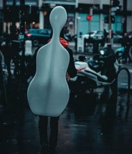 Person carrying cello in a hard case
