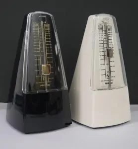 Two metronomes whoing the guitar tip of using one
