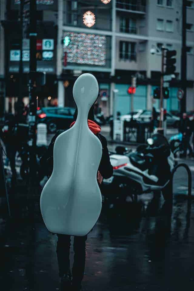 person carrying cello in case on their back
