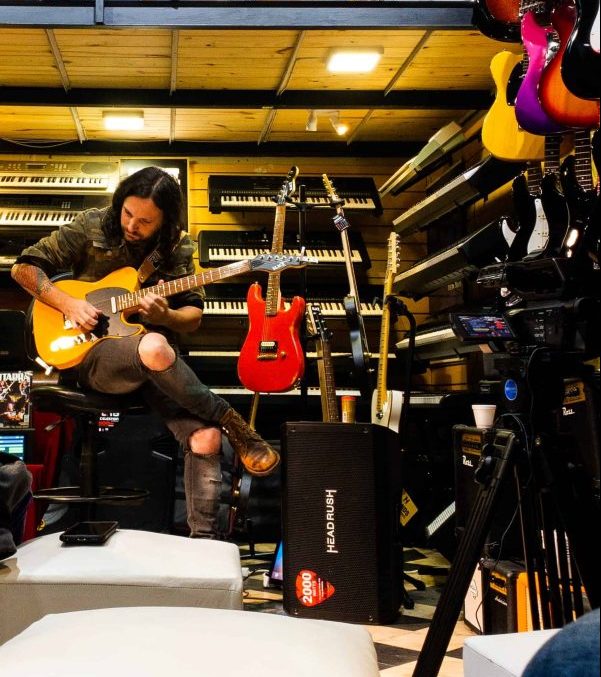 Man playing guitar in a music shop