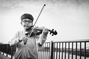 Boy playing violin after breaking down the music